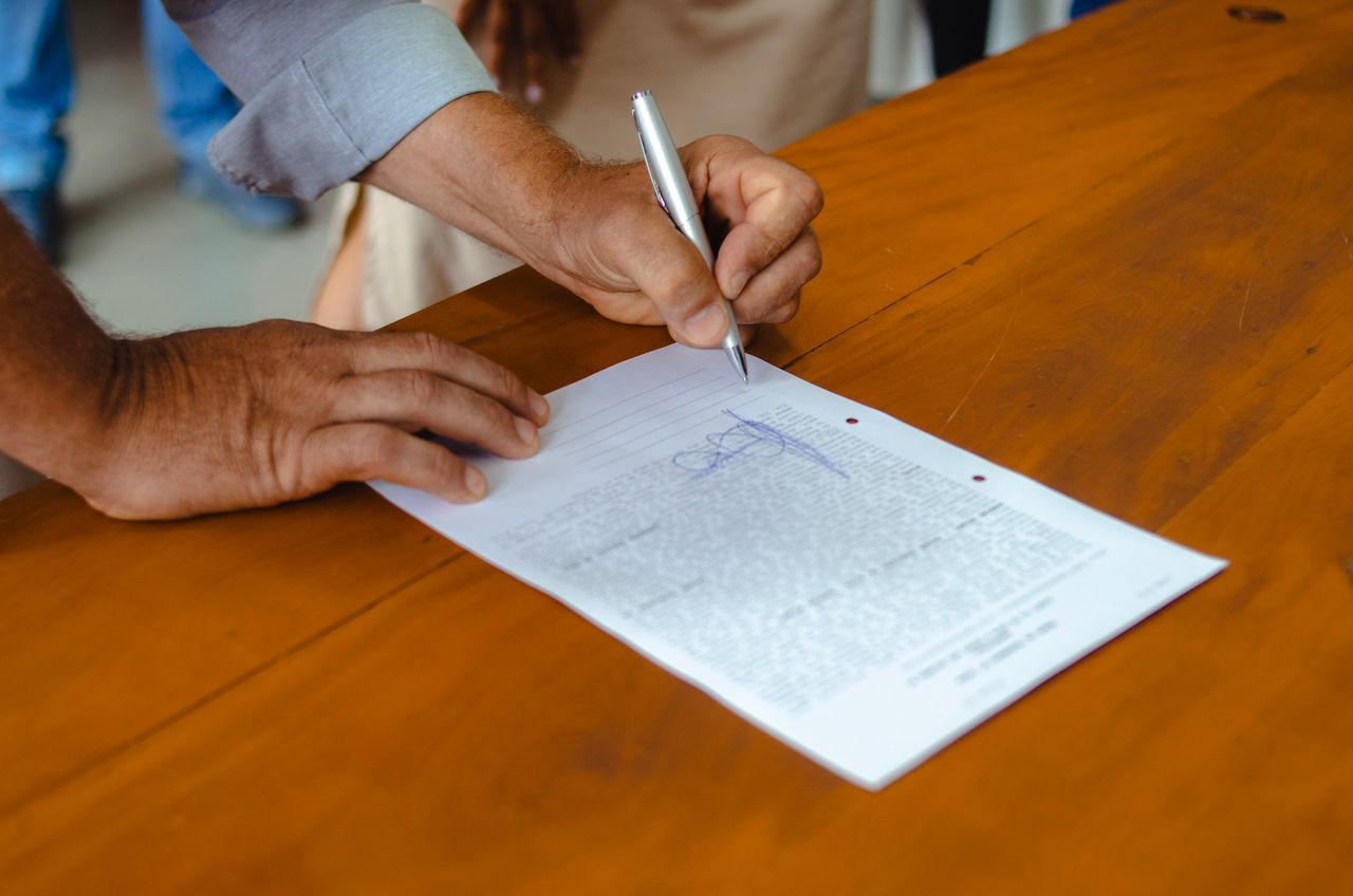 A dog trainer reviewing paperwork with a client before a session